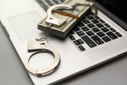 Handcuffs keyboard and dollars above