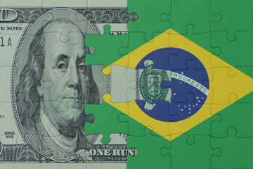 puzzle with the national flag of brazil and dollar money banknote. macro.concept.