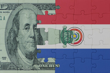 puzzle with the national flag of paraguay and dollar money banknote. macro.concept.