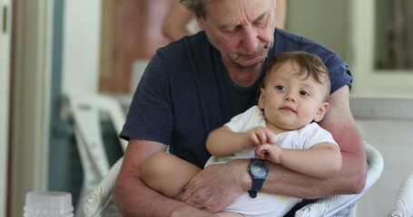 Candid grand-father with grand-son together. Grandparent bonding with grand child toddler