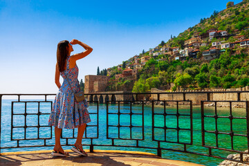 Tourist woman near Kizil Kule Red tower in Alanya, Antalya, Turkey