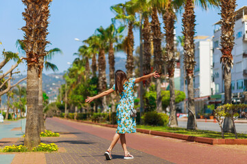 Fototapeta premium Tourist woman on promenade Cleopatra beach in Alanya, Antalya, Turkey