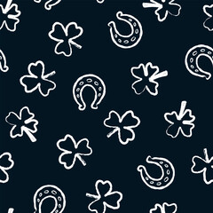 Seamless pattern, symbols of good luck. Clover leaves with three and four petals, horseshoes. St. Patrick's Day. Doodle style. Drawing with chalk on blackboard. Vector illustration in white on black