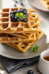 Homemade belgian waffles with blueberries and honey