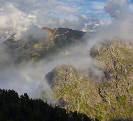 closeup rocky mountain chain in dense clouds