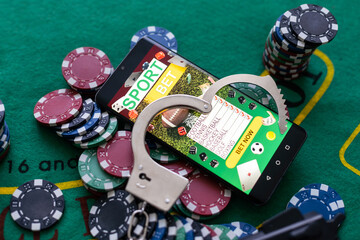 Cards cubes and chips Handcuffs close-up. Royal flush poker. Prohibited gambling concept, internet...