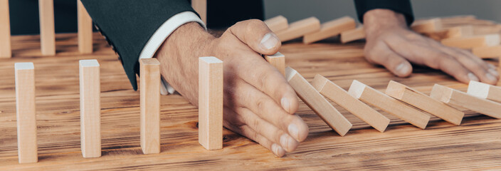 Risk and Strategy in Business, Image of hand stopping falling collapse wooden block