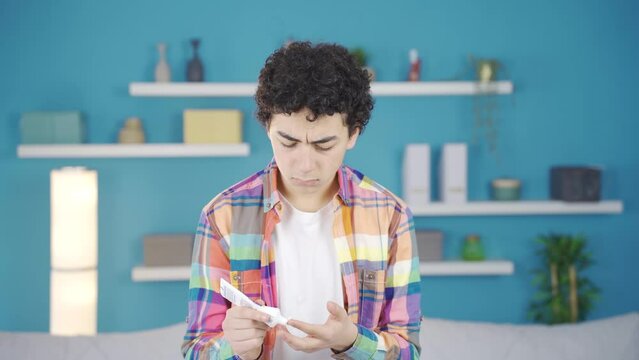 Boy applying cream to his skin.