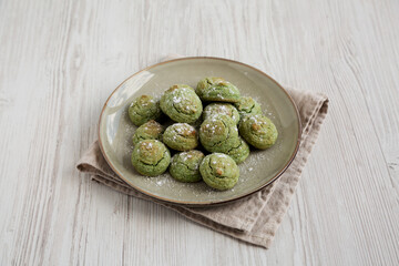 Homemade Soft Amaretti Cookies with Pistachio on a Plate, side view.