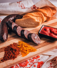 Tasty blood sausage with spices, white bread, horseradish on a wooden cutting board