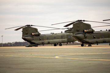 Fototapeta na wymiar Pair of Twin rotor heavy lift military helicopters.