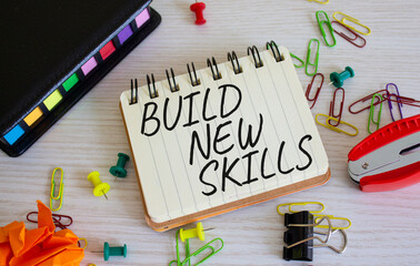 Build New skills symbol. Concept word Build New skills on white notebook. Beautiful wooden background. Business and Build New skills concept. Copy space