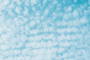 Blue skies with white clouds background with space for text, blue cloudy skies texture. 