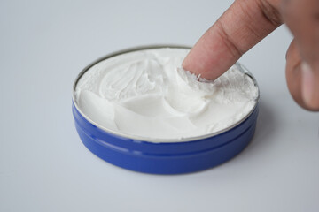  man applying beauty cream onto skin 