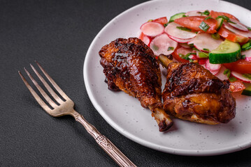 Delicious nutritious dish consisting of grilled chicken legs with a salad