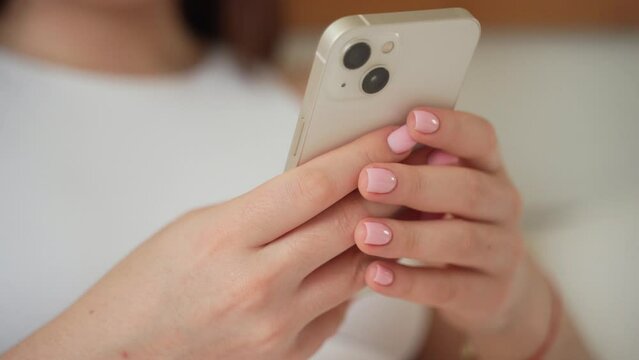 Young woman hands using smartphone close up. Teenage girl scrolling, watching video reels, chatting, messaging social media, online shopping. Technology in daily life Generative AI