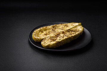 Delicious zucchini cut into two halves baked with salt, spices and herbs