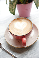 a cup of late coffee with flower shape design on top at cafe 