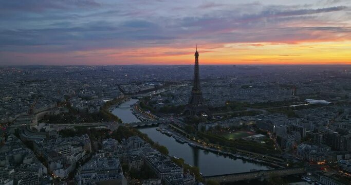 Beautiful view of famous Eiffel Tower in France with colorful twilight romantic sky. Wide establishing aerial morning sunrise or sunset of paris city center best travel destinations landmark in Europe