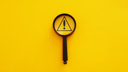 Fotobehang Magnifier glass with triangle caution warning sign for notification error and maintenance concept © Andrii