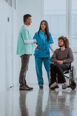 Fototapeta premium Doctor and a nurse discussing a patient's health while the patient, who is in a wheelchair, is present beside them.