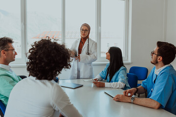 A group of multiethnic medical professionals including doctors, surgeons, and nurses are gathered...