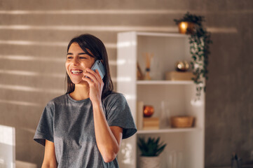 Happy young businesswoman talking on her cell phone, laughing and enjoying.