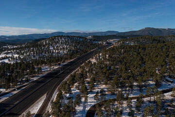 wide shot of alpine landscape with large highway splitting through the middle of the frame