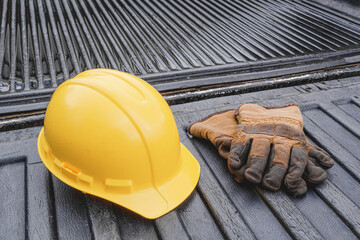Hardhat and work gloves during a wet day on pickup truck bed © Kevin Brine