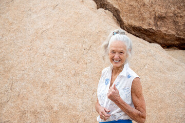 Senior Woman in the desert expressing wellness and heath. 