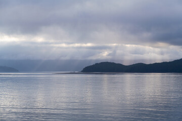 Fototapeta premium Sunbeam sunrise along islands of Inside Passage Cruise, British Columbia, Canada.