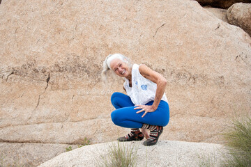 Senior Woman in the desert expressing wellness and heath.  - 597632298