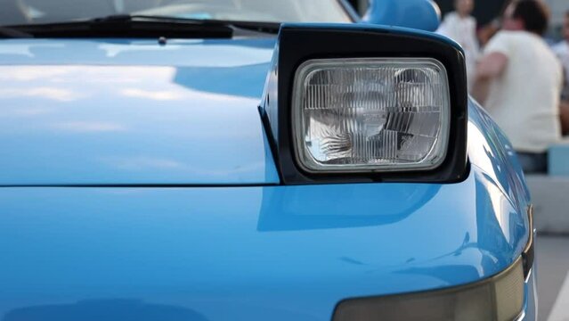 blue sport retro car with retractable headlights. sport car at the start.