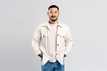 Portrait of successful Asian businessman wearing modern casual clothes isolated on gray background