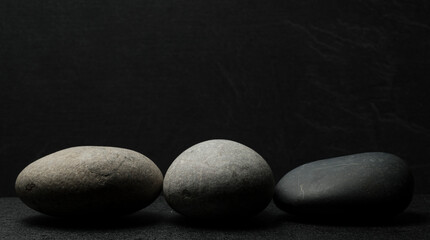 zen stones for podium background .three zen stones on dark background with shadows