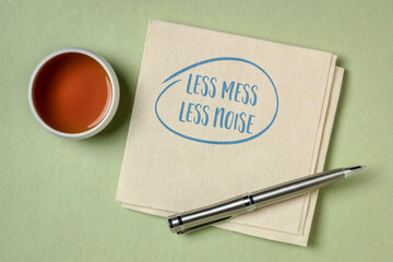 less mess, less noise - inspirational note on a napkin, decluttering, simplicity and minimalism concept