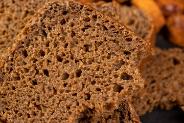 pieces of black rye bread from mixed wheat flour with rye flour