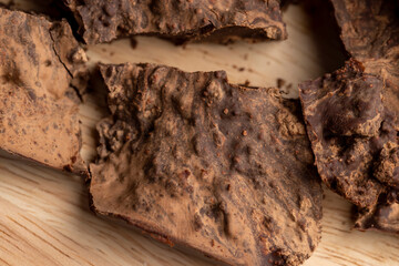 Pieces of chocolate with added cocoa and sugar