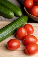 Ripe red fresh tomatoes on a board