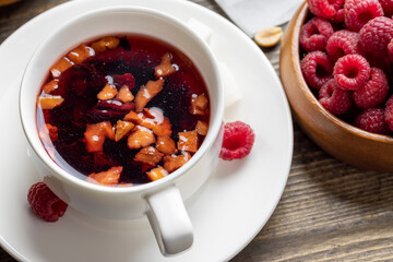 Red hot tea with raspberries, close up