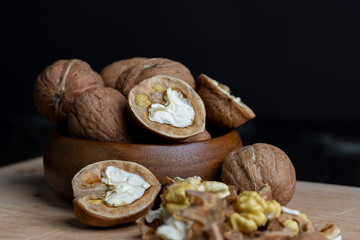Open and broken walnut shells lying on the table