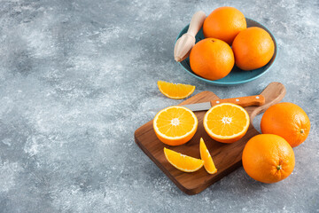 Top view fresh sliced orange on dark background ripe mellow fruit juice color citrus tree citrus, Whole and sliced ripe oranges placed on marble background, half orange fruit.