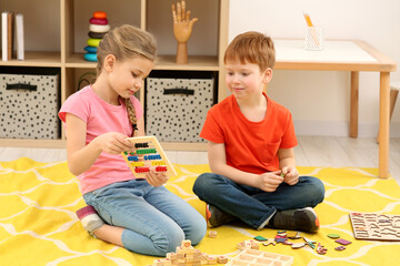 Children playing with different math game kits on floor in room. Study mathematics with pleasure