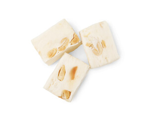 Pieces of delicious nougat on white background, top view