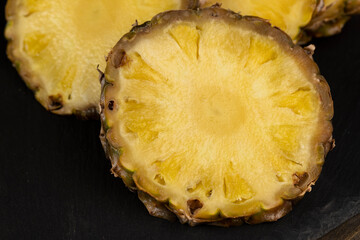 sliced pulp of peeled ripe pineapple , close up