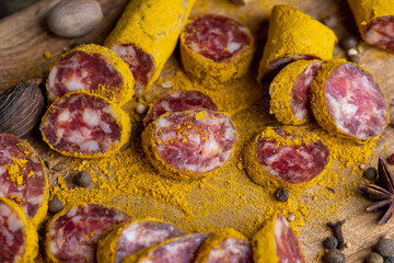 Sliced pork salami with spices and lots of turmeric