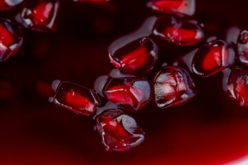Grains of red ripe pomegranate close up
