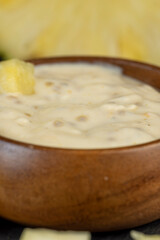 milk pineapple yogurt with pieces of pineapple and other fruits