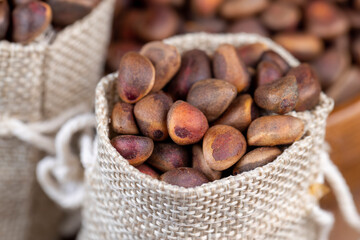 a bunch of pine nuts in the shell