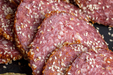 Sliced beef sausage with spices and lots of sesame seeds